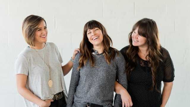 Three women, laughing together.  